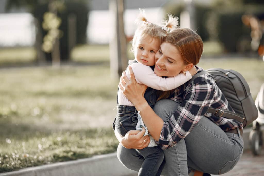 different parenting styles - mother hugging his little girl 