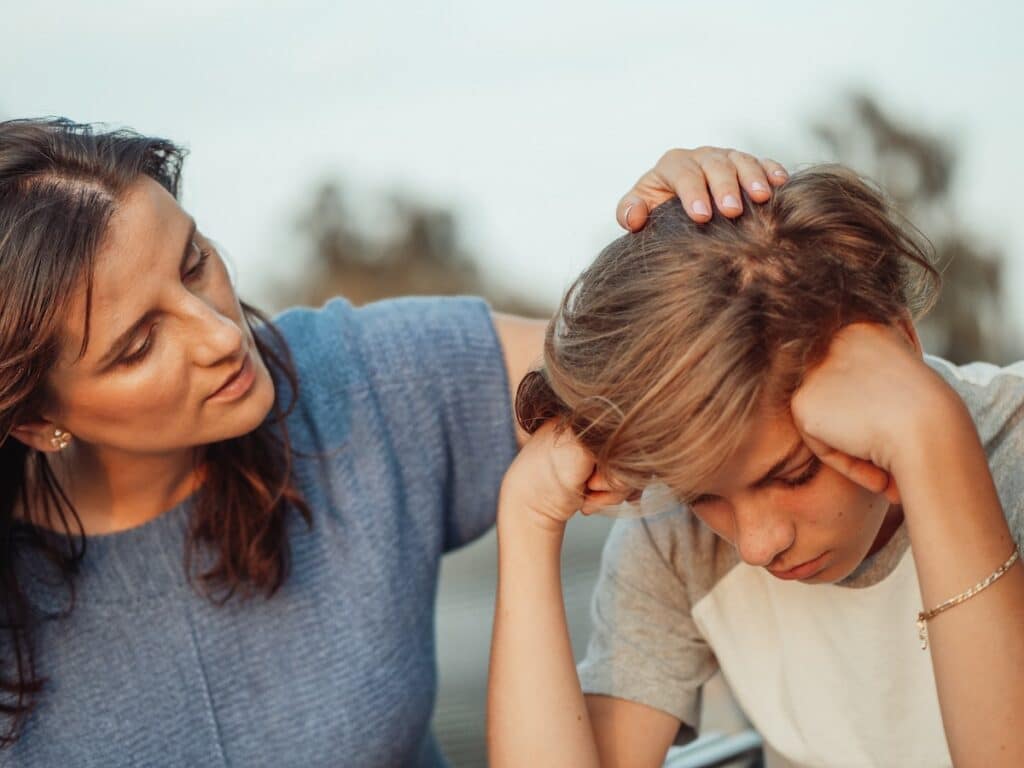 A mother and her strong-willed son share a tender moment of support and understanding