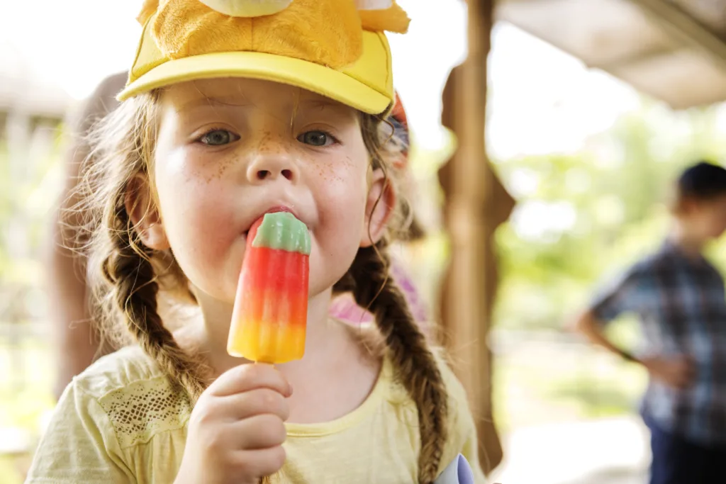  Spoiled child - Little girl eating colorful ice-cream
