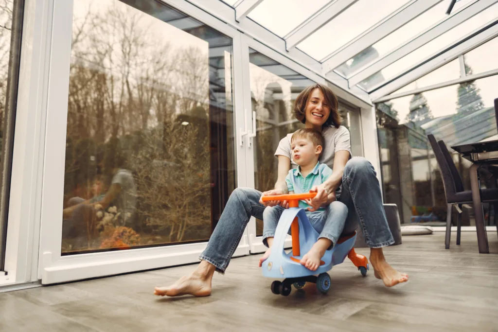 Mom and son riding a toy bike
