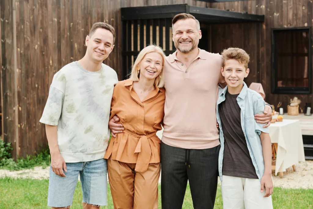 family with two kids, smiling at the camera