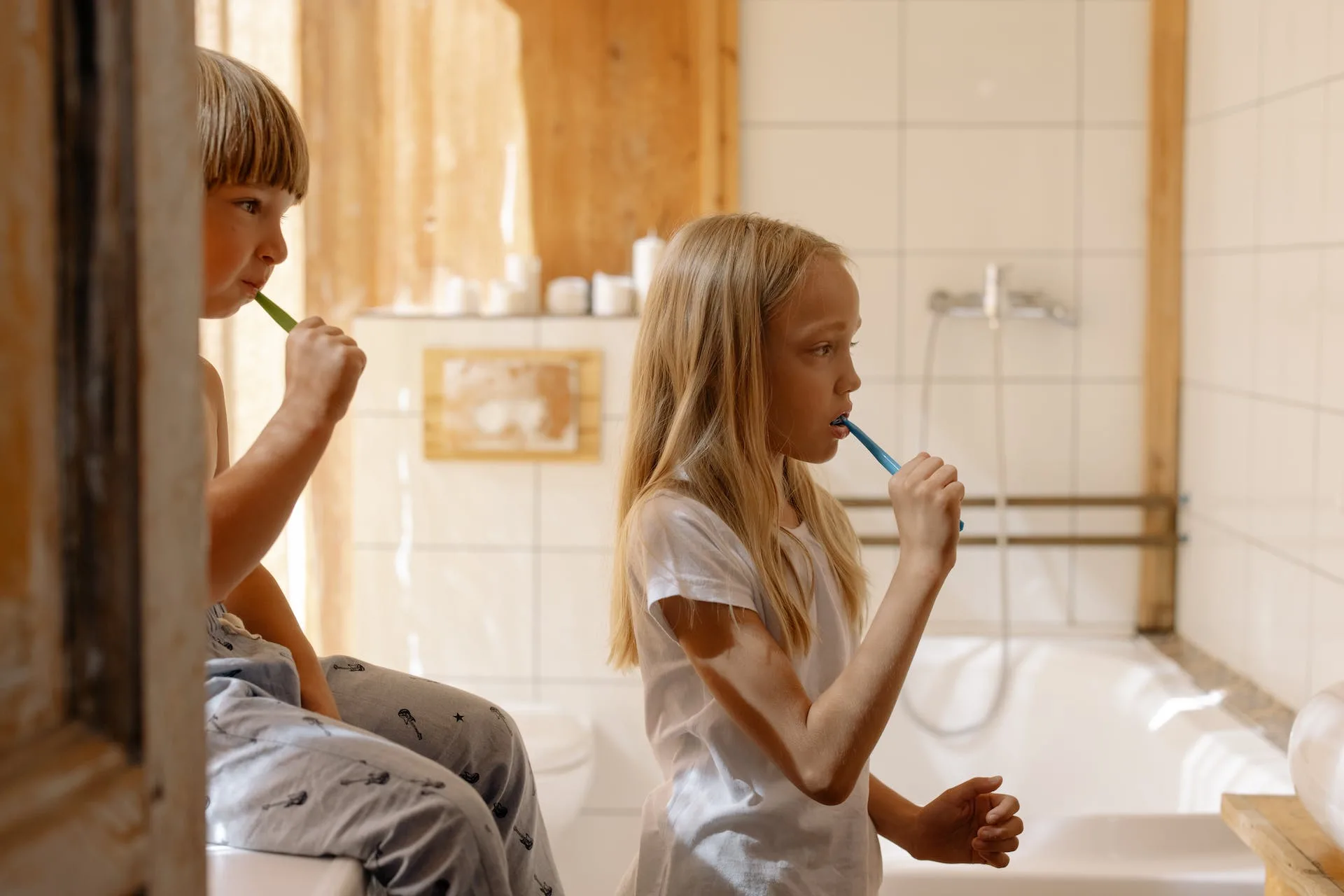 kids brushing teeth togethers, in front of the mirror