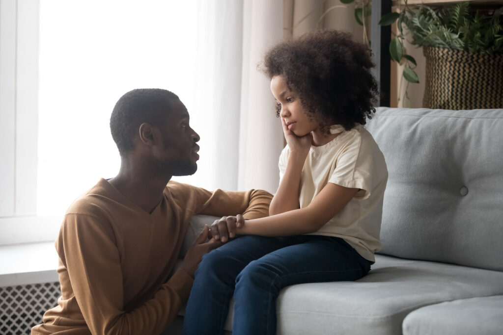 Dad comforting worried daughter 