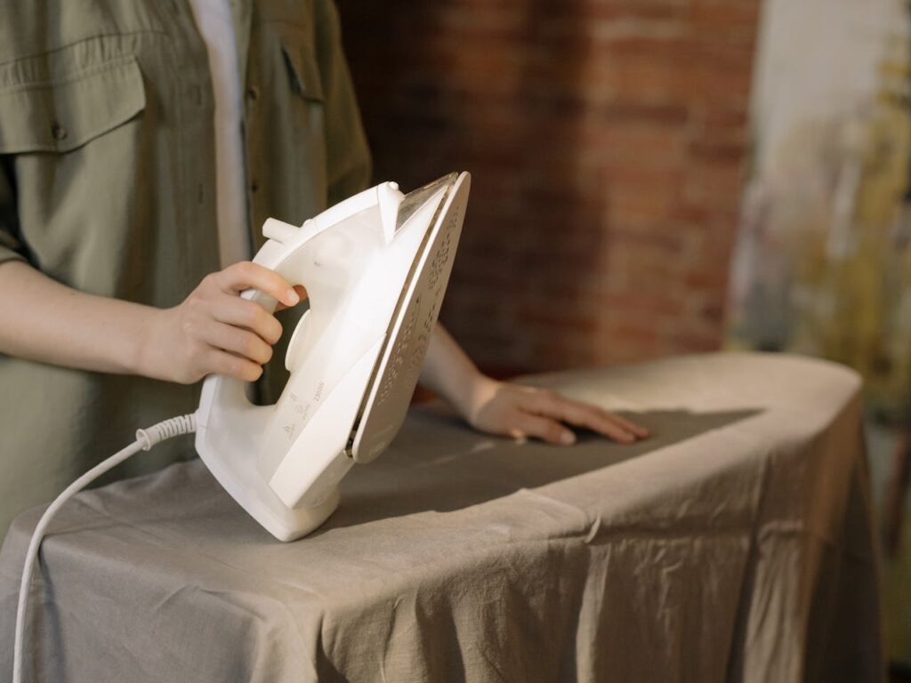 Teenager ironing clothes