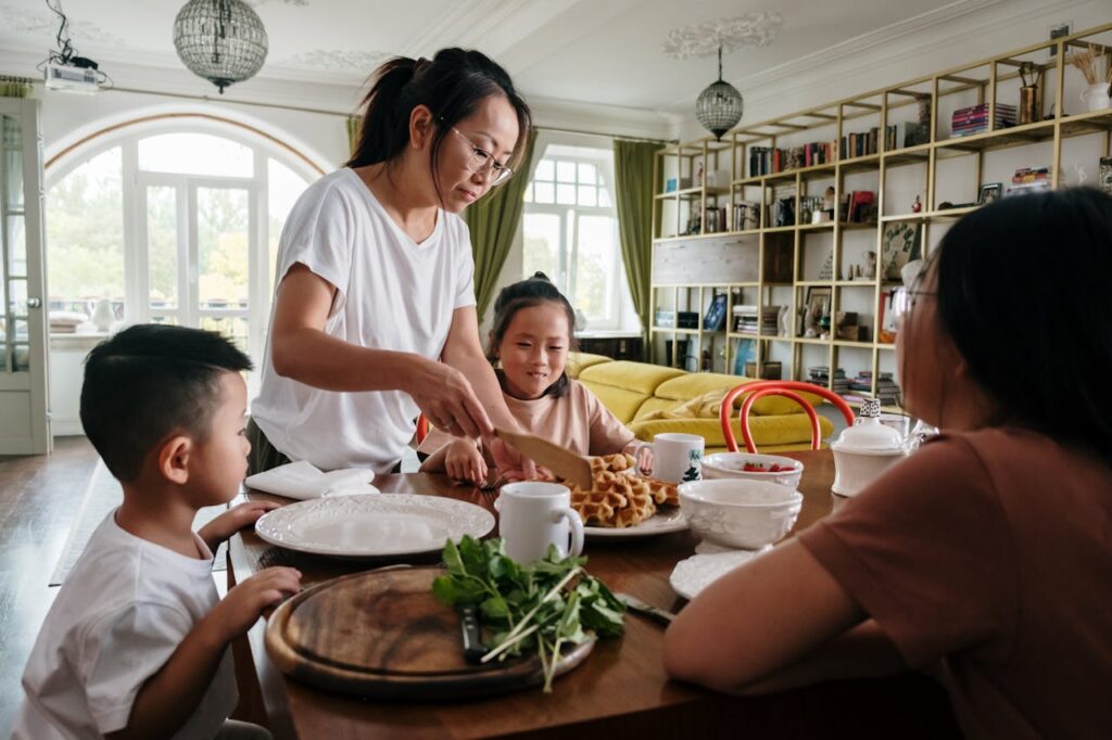 mom and her three children taking breakfast together