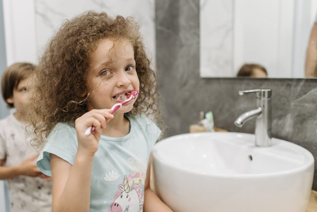 little girl brushing teeth