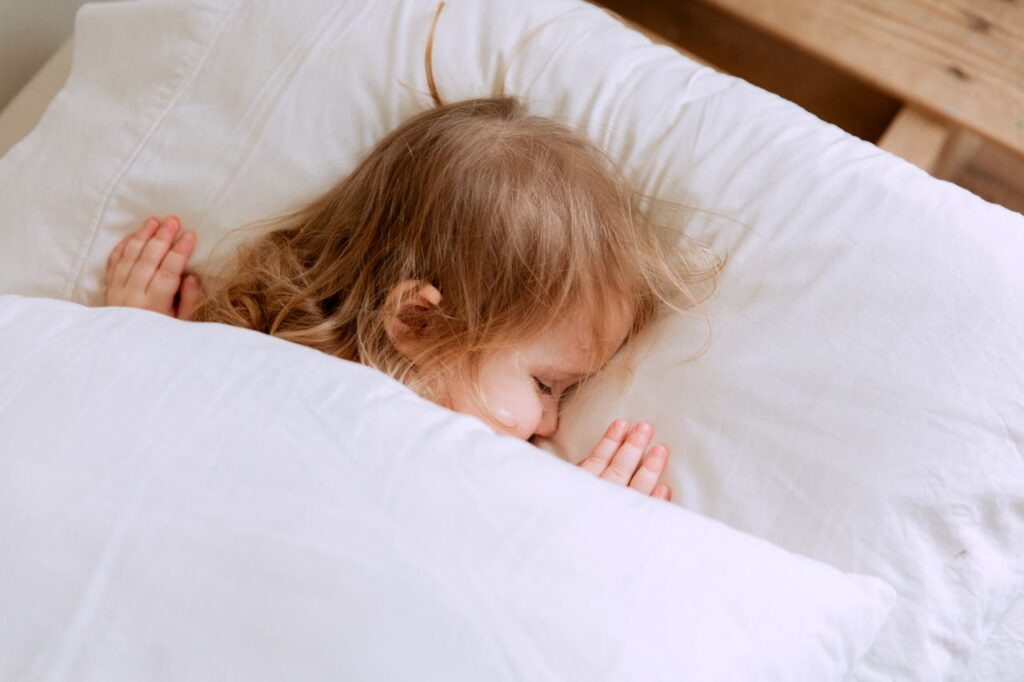 toddler sleeps peacefully alone on a pillow