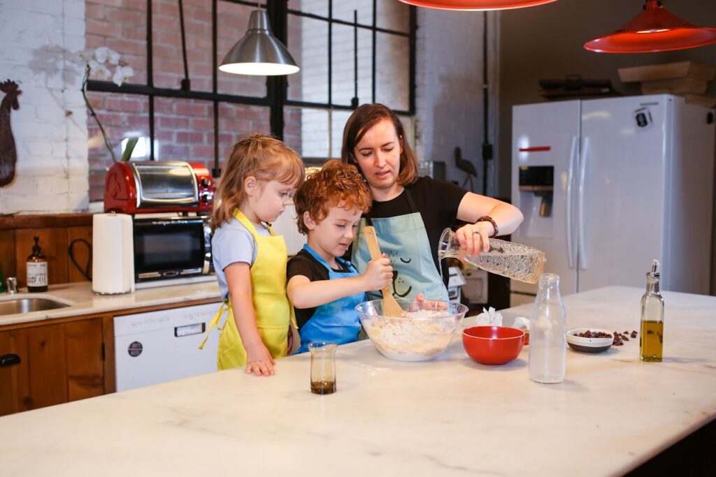 mom cooking with her children, one girl and one boy